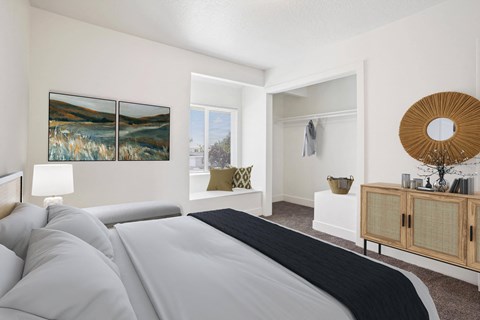 a bedroom with a large bed and a window