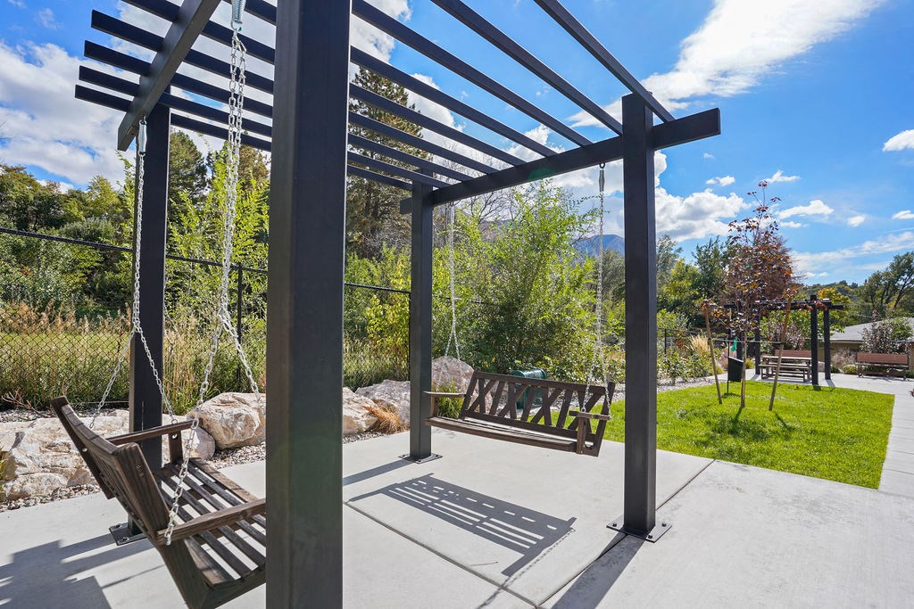 a seating area with benches and a pergola