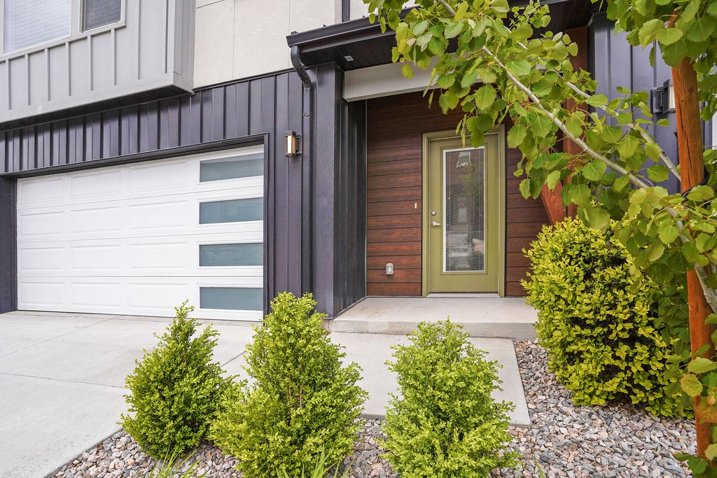 the front of a house with a driveway and a garage door