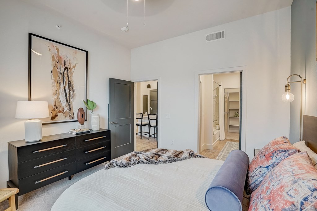 a bedroom with a large bed and a dresser