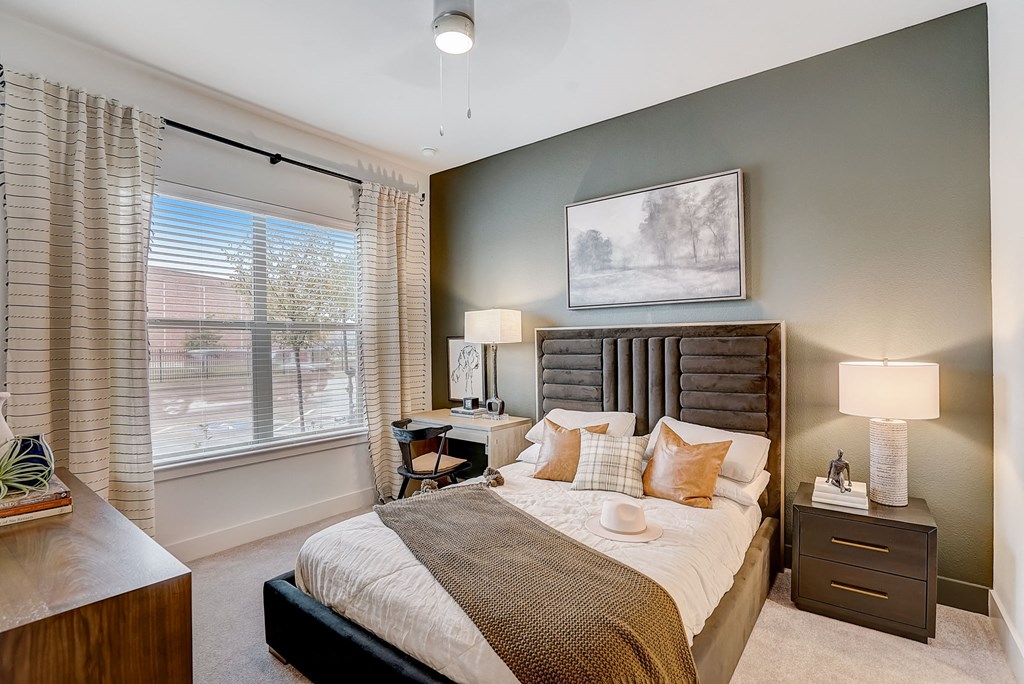 a bedroom with a large bed and a window