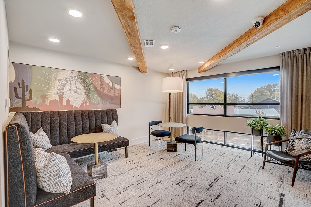 a living room with couches and chairs and a large window
