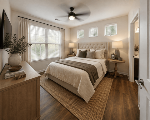 A bedroom with a large bed and a ceiling fan.