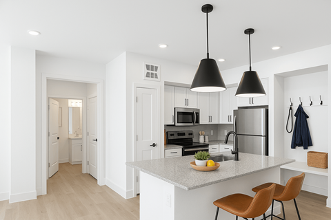 A kitchen with a white countertop and a sink.