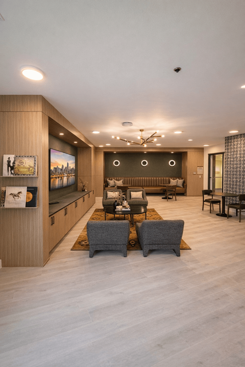 A modern living room with a grey sofa set and a wooden cabinet.
