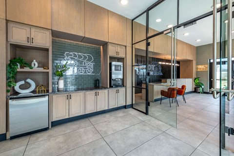 A modern kitchen with wooden cabinets and a glass wall.