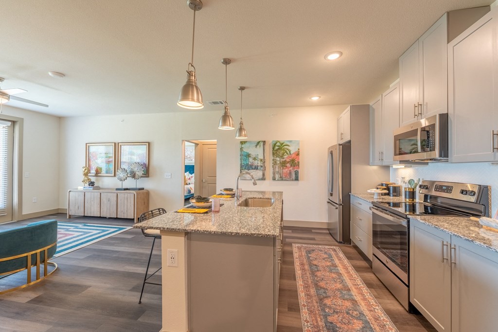 a spacious kitchen with stainless steel appliances and granite countertops at One Preston Station, Celina, TX, 75009