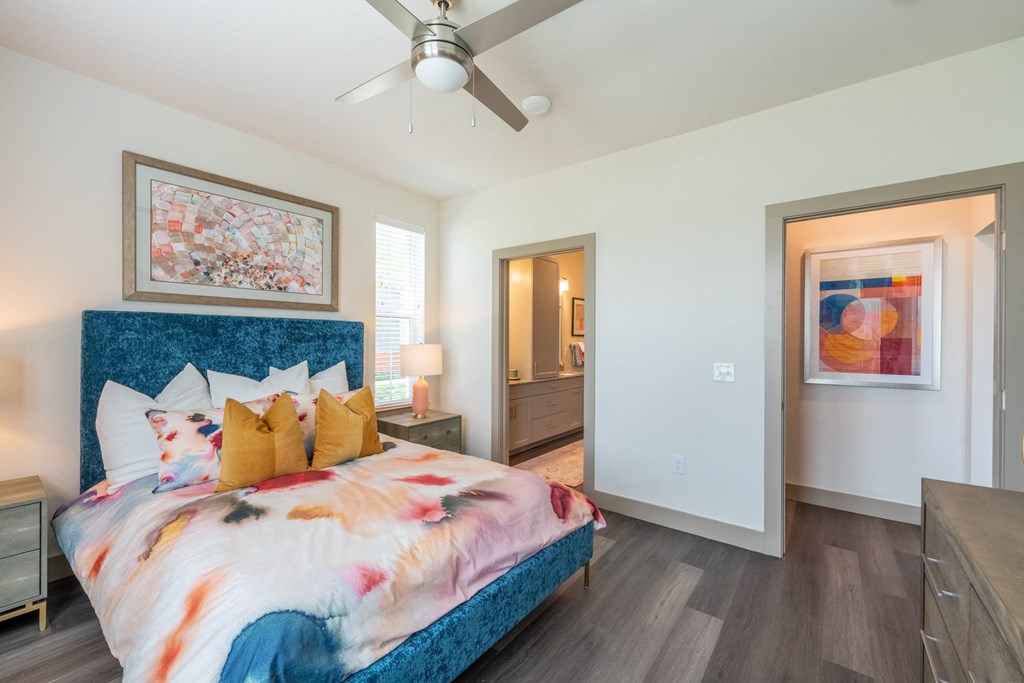 a bedroom with a bed and a ceiling fan at One Preston Station, Celina, TX, 75009