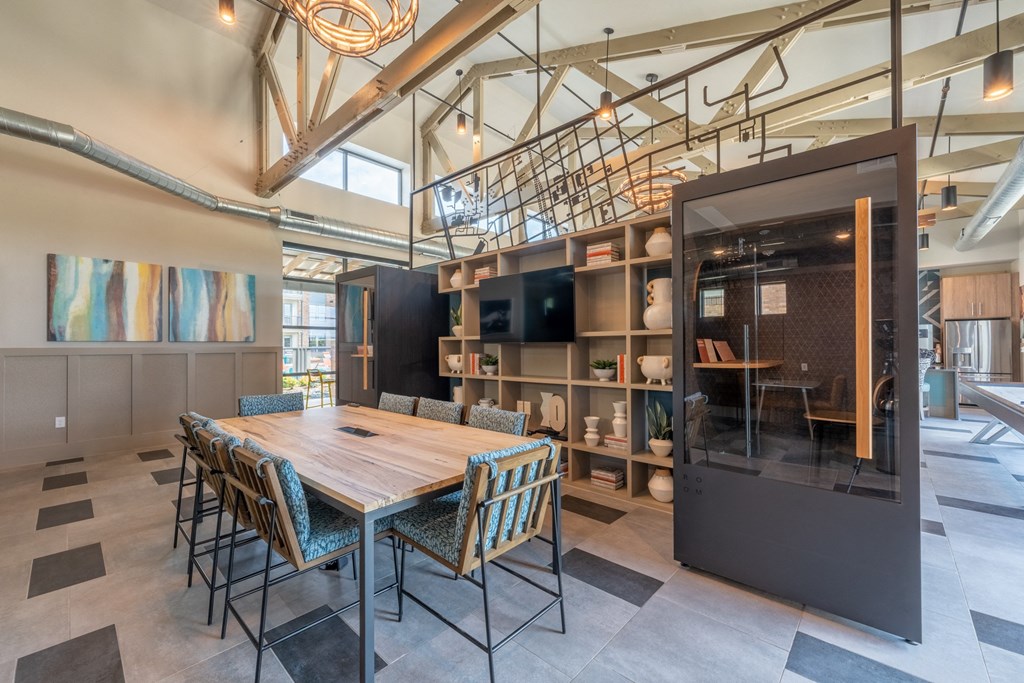 a large table and chairs in a room with a bookshelf at One Preston Station, Texas