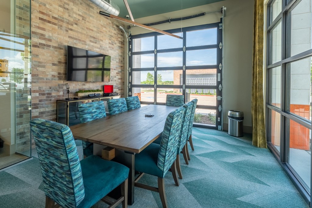 a conference room with a wooden table and blue chairs at One Preston Station, Celina, 75009
