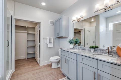 A bathroom with a toilet, sink, and medicine cabinet.