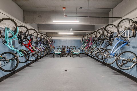 A bike rack with many bikes hanging on it.