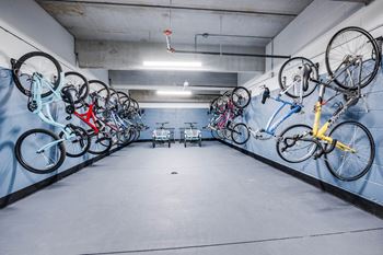 A bike rack with many bikes hanging on it.