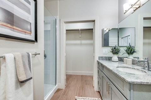 A bathroom with a towel hanging on the door.