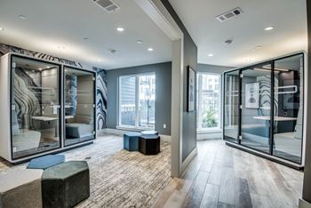 A modern room with glass walls and a carpeted floor.