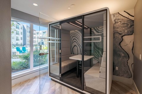 A modern room with a glass door and a zebra print rug.