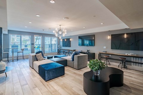 A modern living room with a black coffee table and a large window.