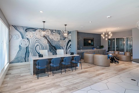 A modern office space with a large mural on the wall and wooden flooring.