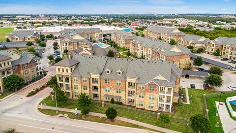 Aerial view of Auberge of Burleson apartments in Burleson TX with resort-style swimming pool and landscaped grounds.