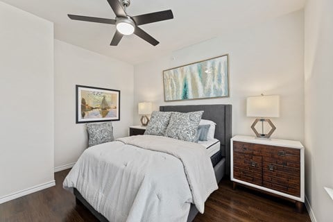 Spacious bedroom with ceiling fan at Auberge of Burleson apartments in Burleson TX.