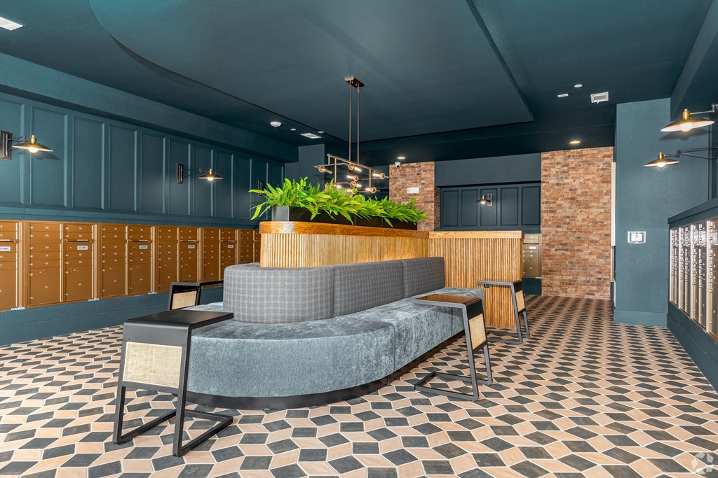 a lobby with couches and chairs and a reception desk