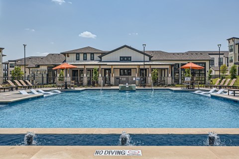 Resort style pool with fountains and clubhouse at The Westerly Apartments, Midlothian, TX