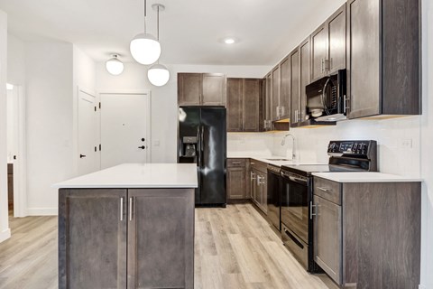 a modern kitchen with stainless steel appliances and white counter tops
