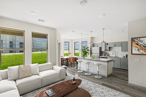 A modern living room with a white sofa and a coffee table.