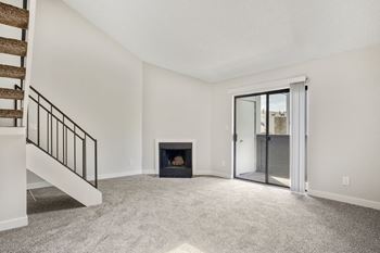 a living room with a fireplace and a staircase  at Hilltop View in Denver, CO