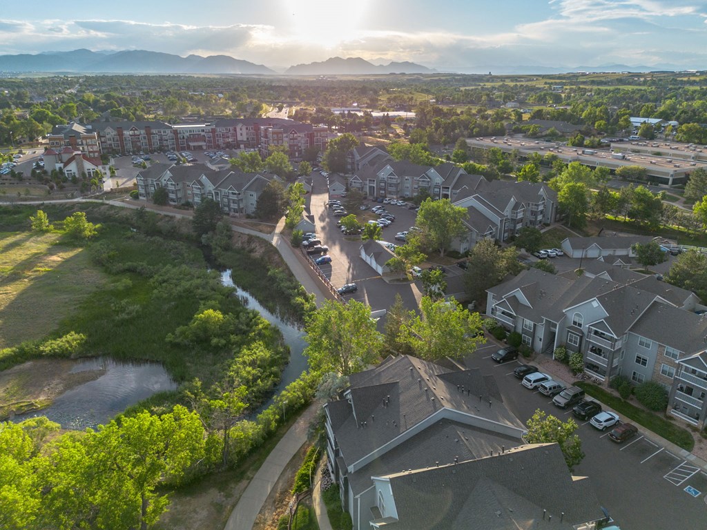 an aerial view of a neighborhood with houses and trees and a river
