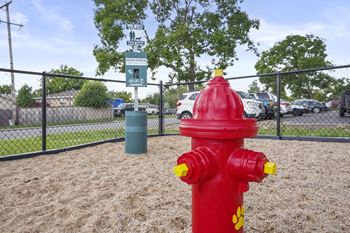 a red fire hydrant in a dog park at Hilltop View Apartments
