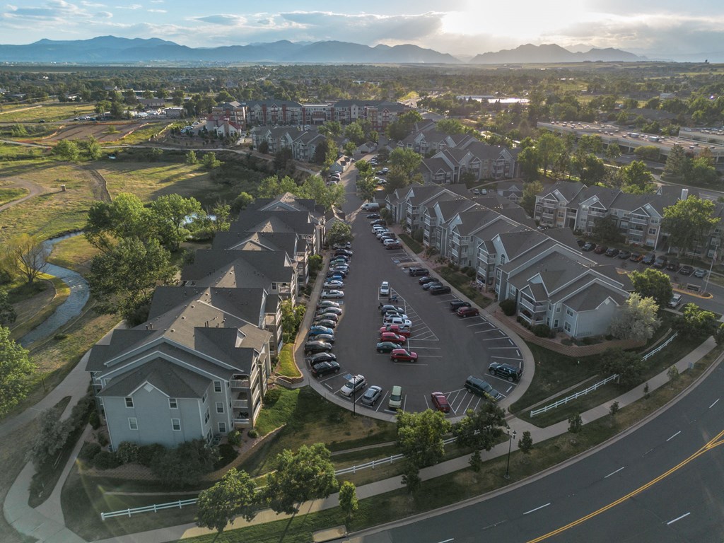 an aerial view of a neighborhood of houses with cars parked