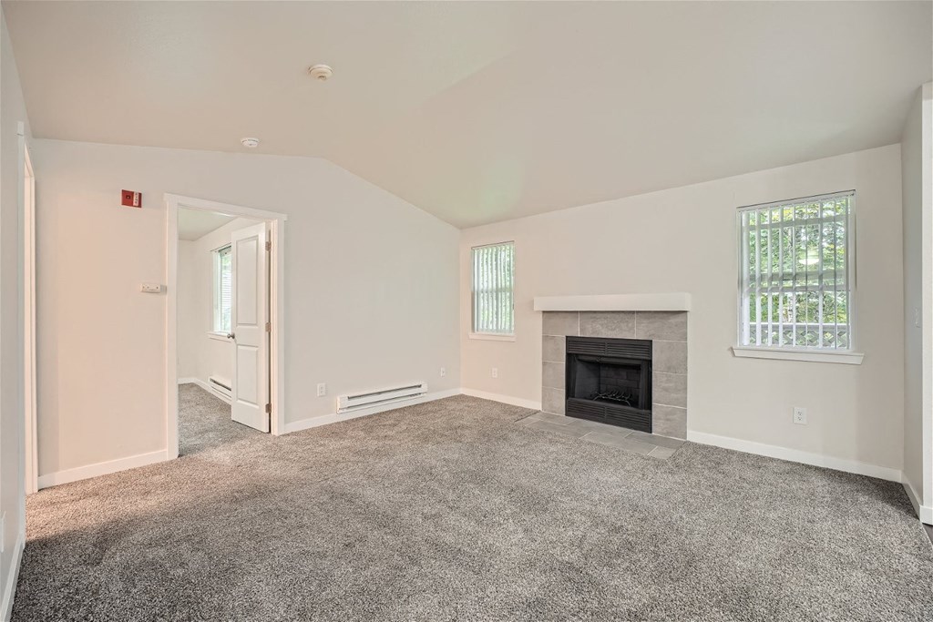 A living room with a fireplace at Bellwether Apartments in Olympia, Washington