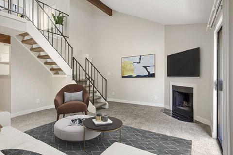 A living room with a fireplace and a painting on the wall.