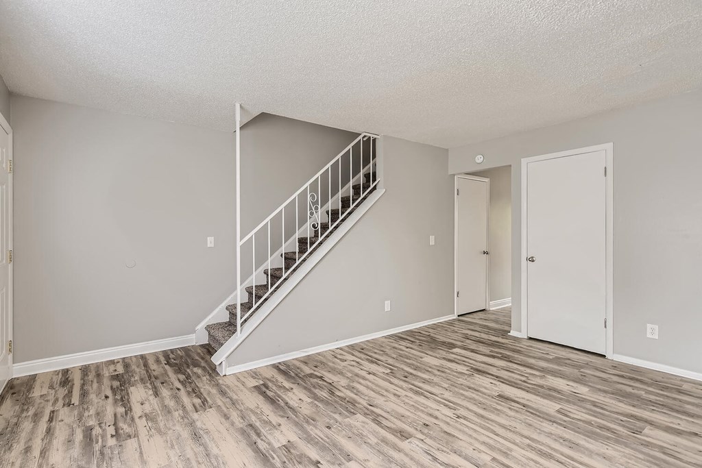 A living Room and staircase at Alder Square Rental Townhomes