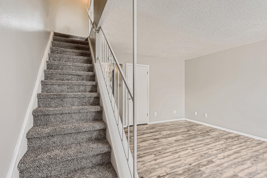 A living Room and staircase at Alder Square Rental Townhomes