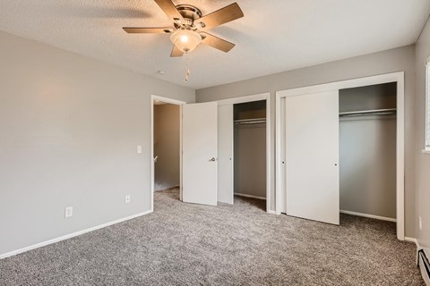 A bedroom with a large closet at Alder Square Townhomes Apartments