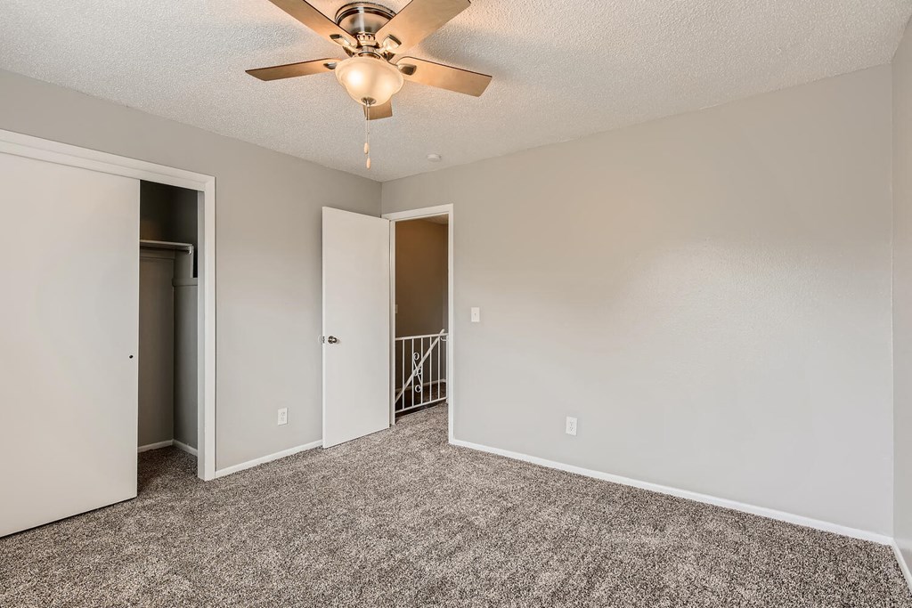 A bedroom with a closet at Alder Square Rental Townhomes