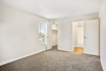 a bedroom with white walls and carpet  at Hilltop View in Denver, CO