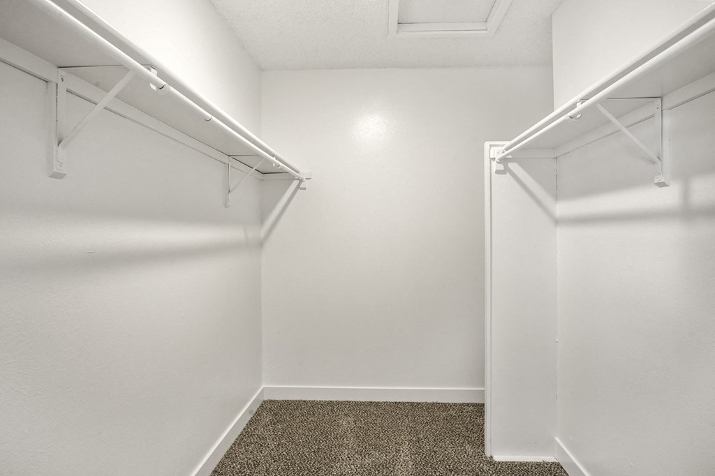 A spacious walk-in closet at Hilltop View Apartments