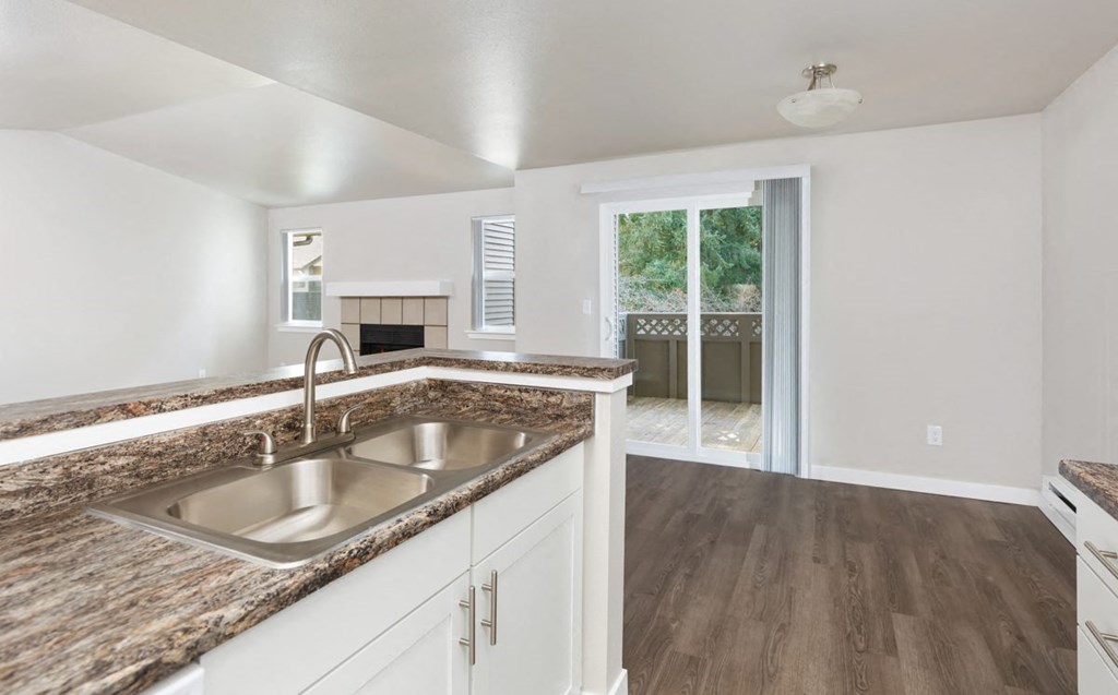 A kitchen with a sink and a counter top.