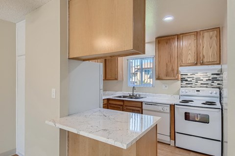 a kitchen with white appliances and wooden cabinets
