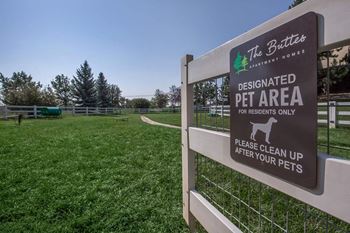A sign for a pet area at  at The Buttes Apartments Loveland, CO