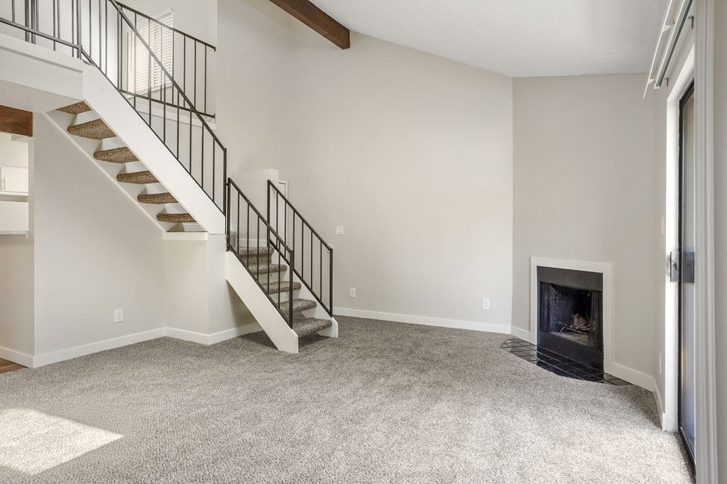 A living room with a fireplace and loft at Hilltop View Apartments