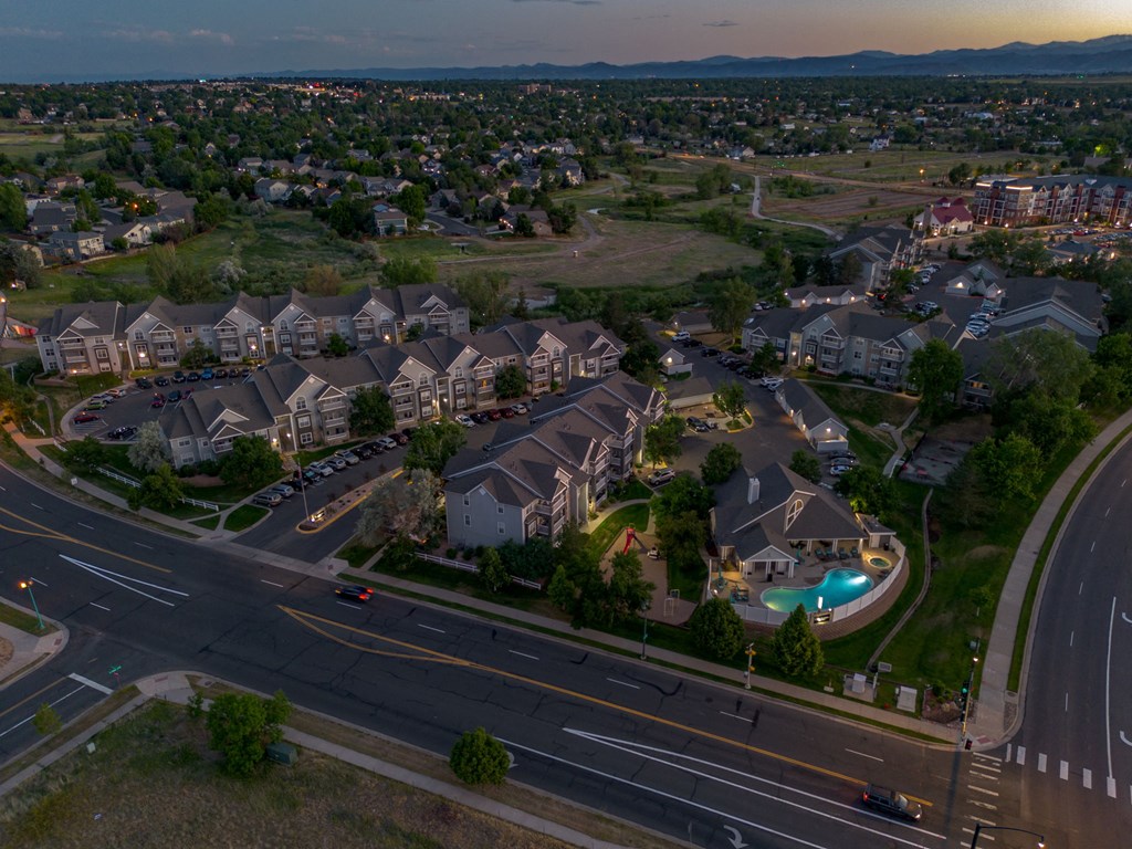 an aerial view of a neighborhood with houses and a road