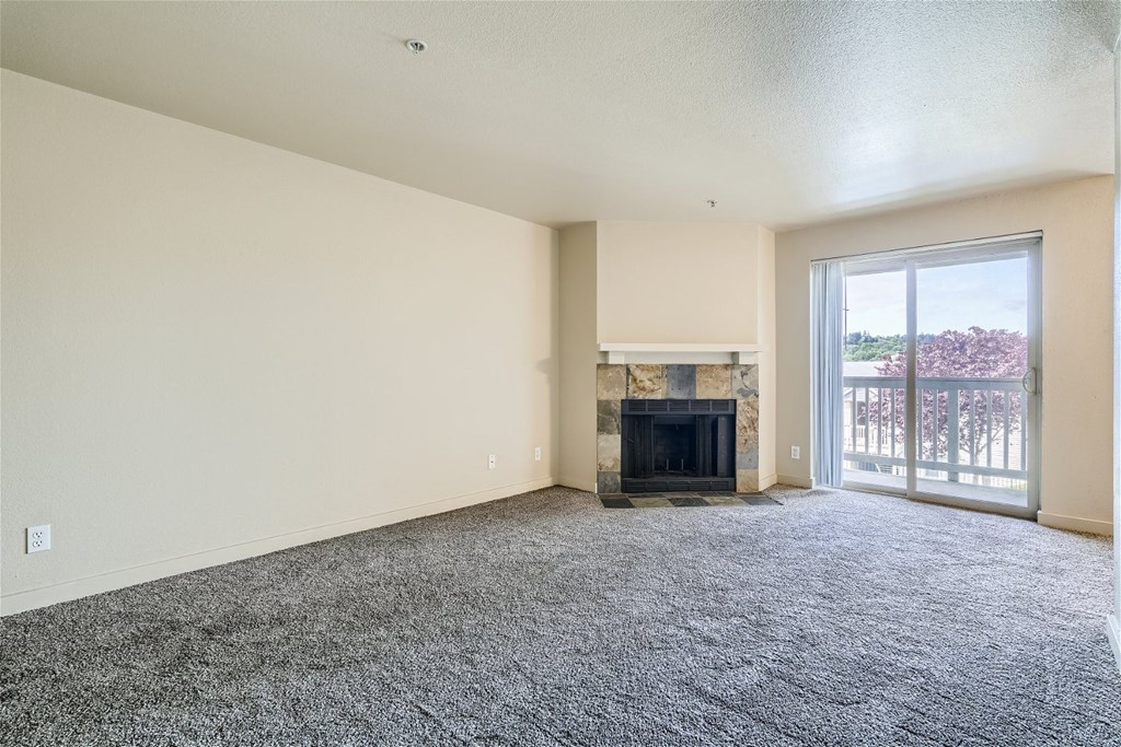 A Renovated Living Room with a Fireplace at Ladera Apartments