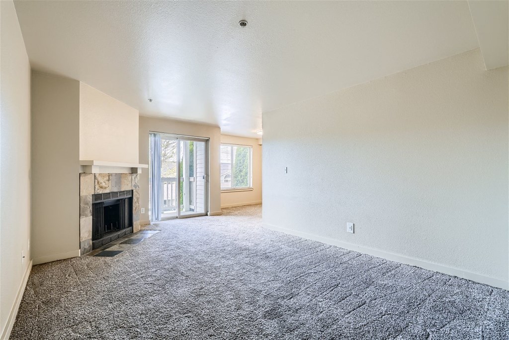 A Renovated Living Room with a Fireplace at Ladera Apartments