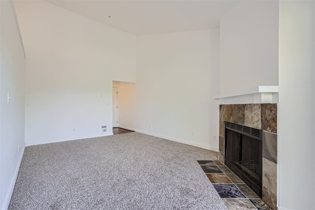 A Renovated Living Room with a Fireplace at Ladera Apartments
