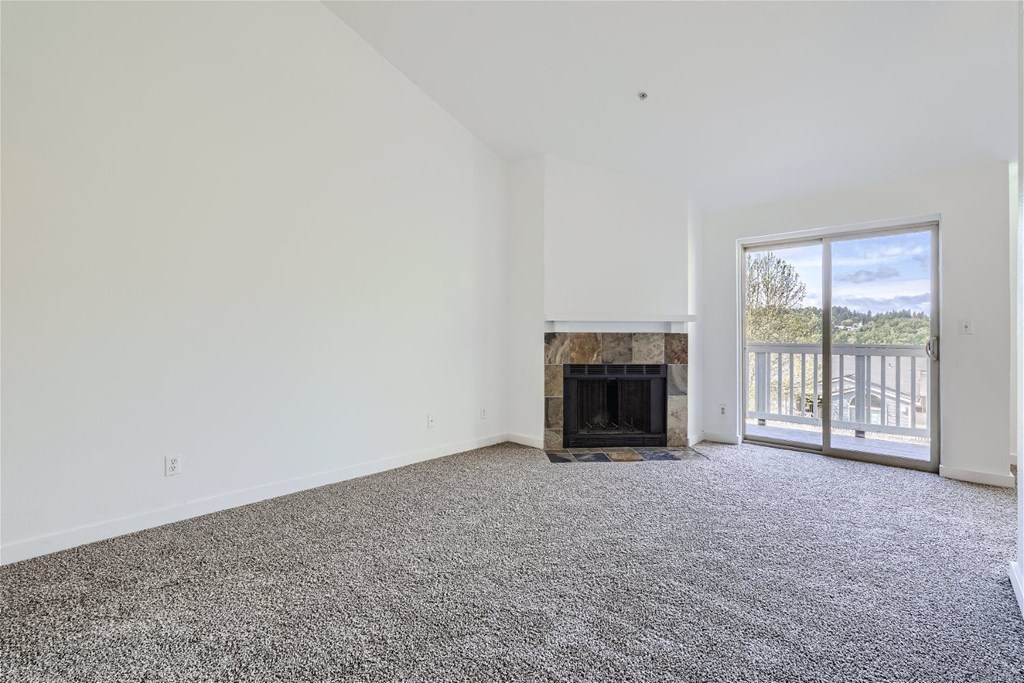 A Renovated Living Room with a Fireplace at Ladera Apartments