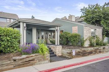 Leasing office with a porch and a sidewalk in front of it  at Hilltop View in Denver, CO